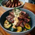 Delicious grilled steak bowl with sauce and grilled zucchini on a plate