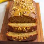 Healthy Greek yogurt banana bread sliced on a wooden cutting board