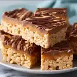 Peanut Butter Rice Krispie Treats drizzled with chocolate swirl, delicious dessert