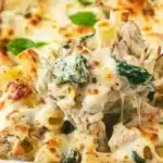 Delicious Spinach and Artichoke Pasta Bake topped with cheese