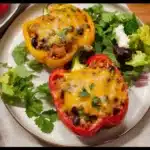 Taco stuffed peppers with extra veggies served on a plate