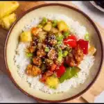 Delicious teriyaki chicken and pineapple bowl topped with green onions.