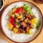 Delicious teriyaki chicken served in a pineapple bowl with colorful vegetables