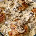 Creamy Mushroom Smothered Chicken Bake with herbs and garnishing