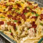 Creamy Chicken Bacon Ranch Pasta Casserole topped with crispy bacon and herbs
