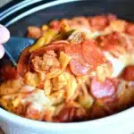 Bowl of Crockpot Pizza Casserole topped with cheese and pepperoni