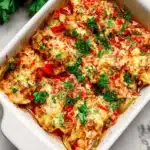 Fajita Chicken Casserole topped with cheese and colorful bell peppers