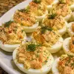 Savory salmon salad deviled eggs plated as a healthy appetizer