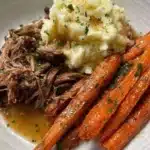 Slow-cooked roast beef served with mashed potatoes and glazed carrots