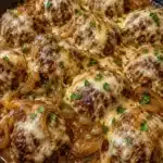 French onion smothered meatballs topped with melted cheese and onions